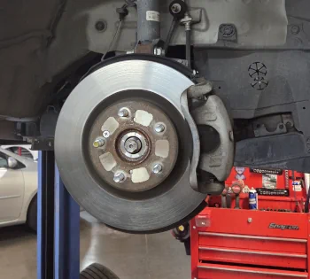 Honda on a lift ready for a brake repair in Tempe, AZ
